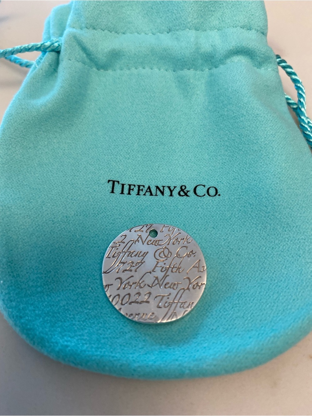 Tiffany & Co. Silver Engraved Round Tag “Notes” Pendant with Signature Pouch - Picture 3 of 3